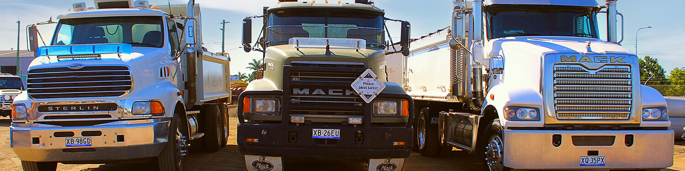 Three trucks for hire lined up near each other