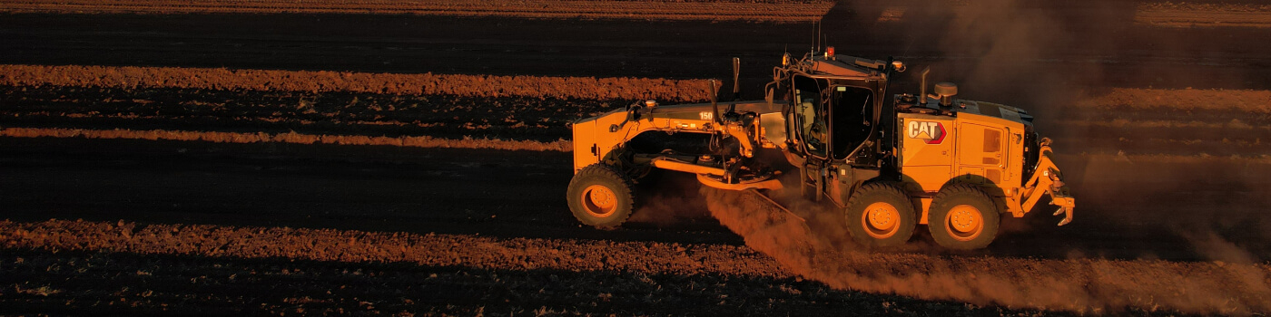 Grader working on soil in farm