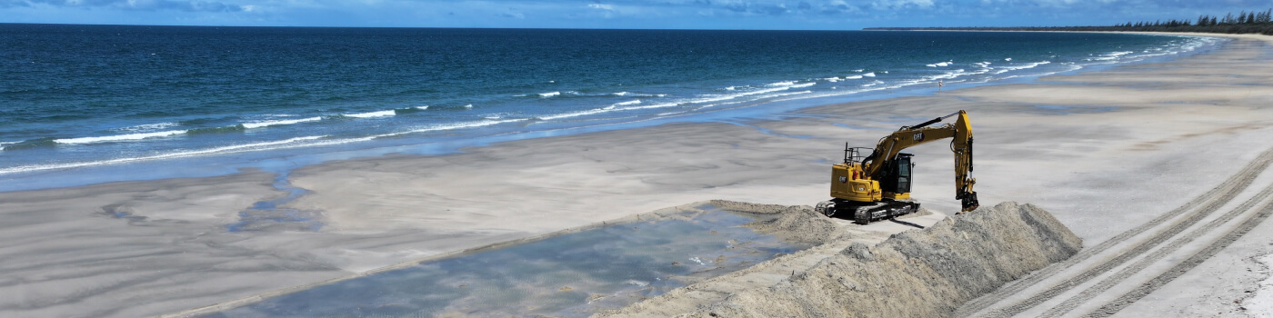 Machinery on beautiful beach for construction work