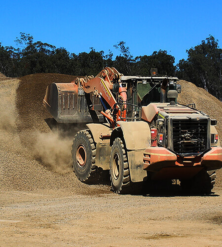 Front end loader drops new rock at quarry