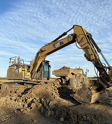 Excavator removing soil during excavation works